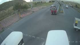 CCTV frame at 0:00 — a red truck at the approach to the junction.